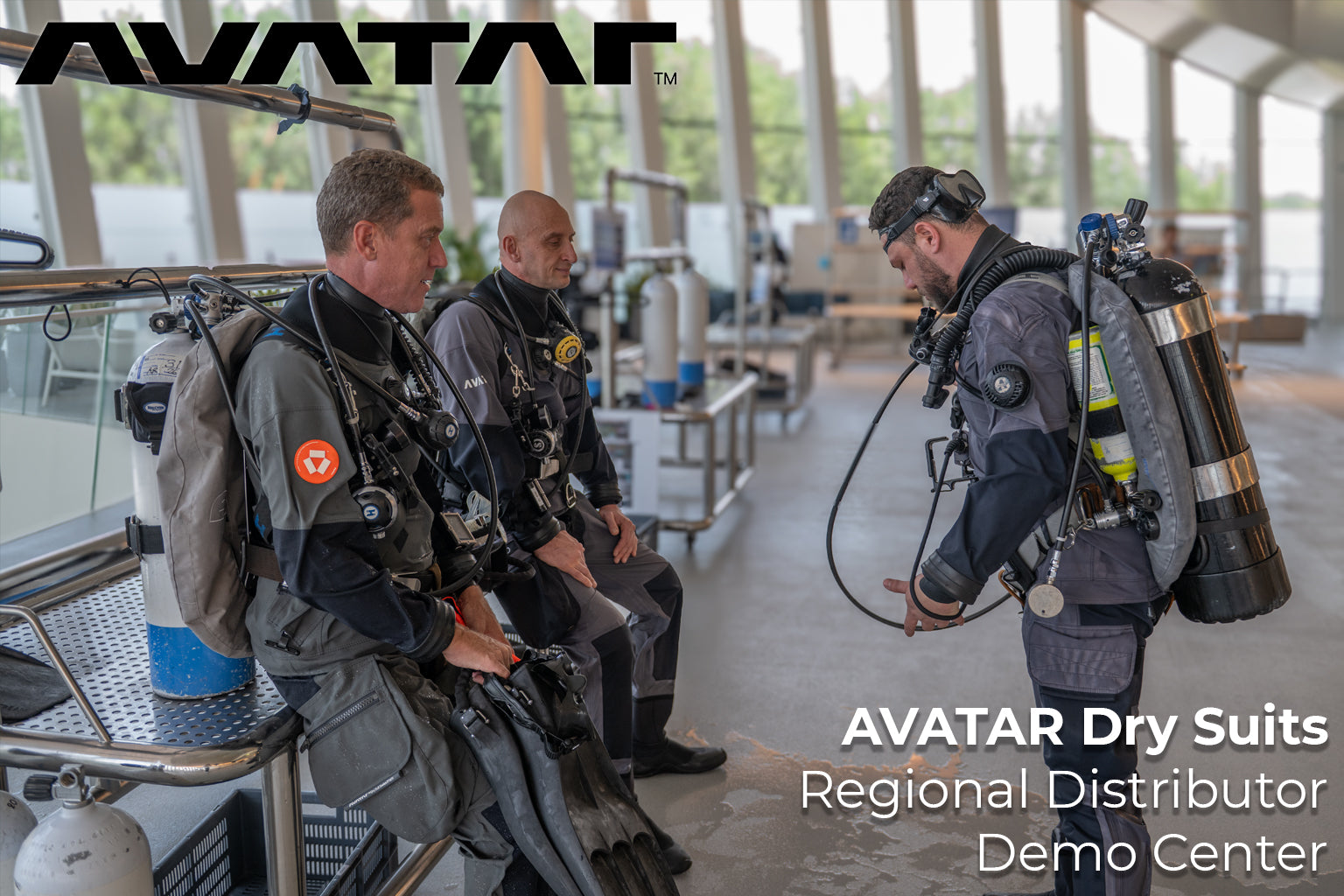 People wearing Avatar dry suits in a demo center setting.