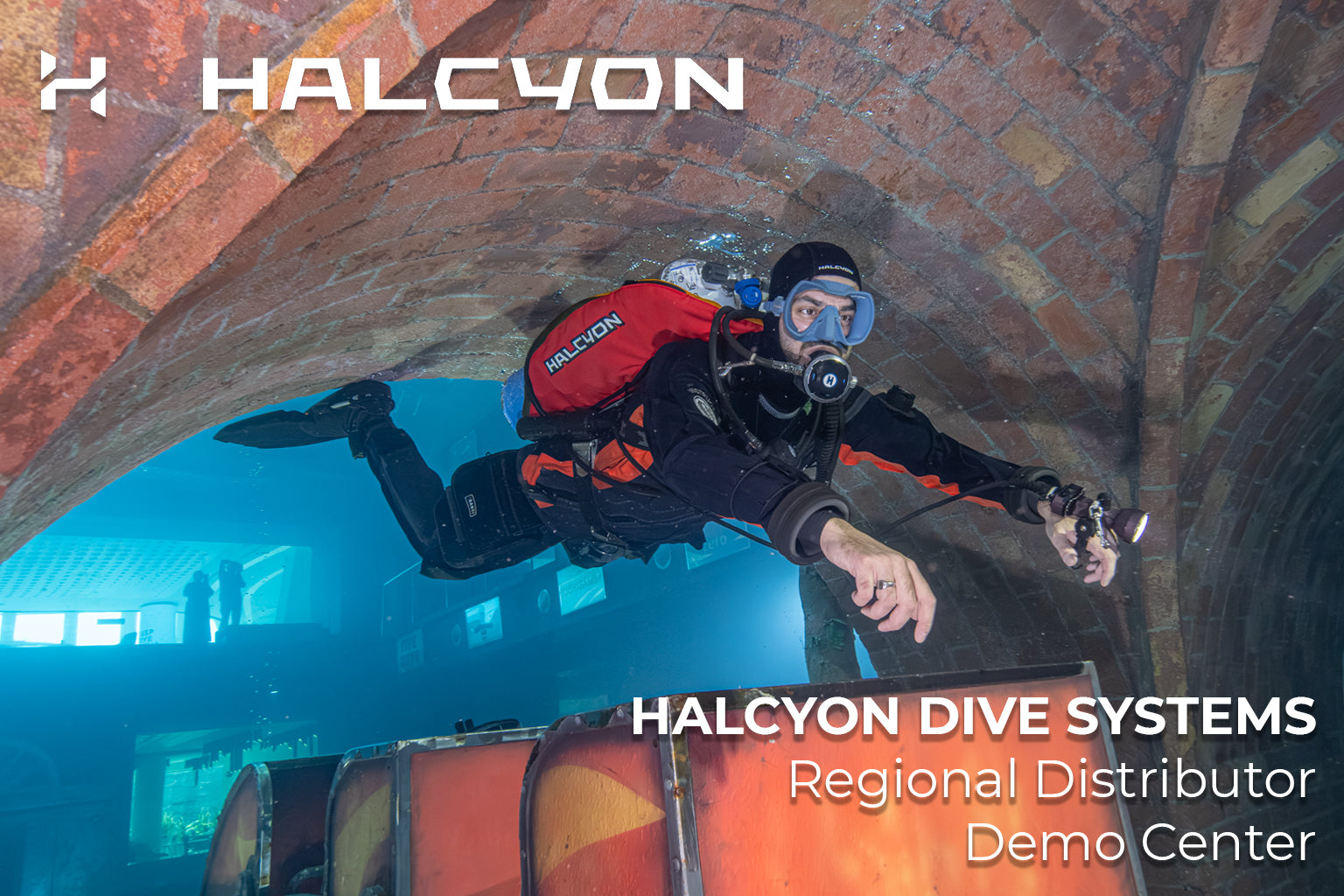 Diver in a tunnel with Halcyon Dive Systems branding