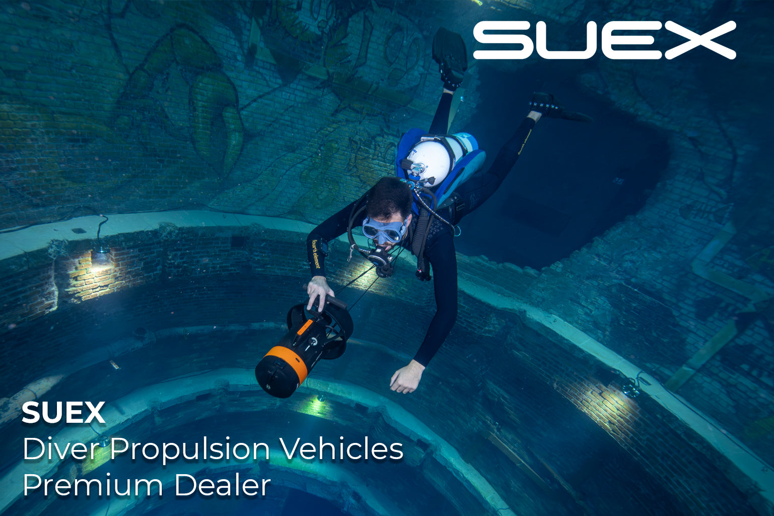 Diver with a SUEX Diver Propulsion Vehicle underwater, with SUEX branding.